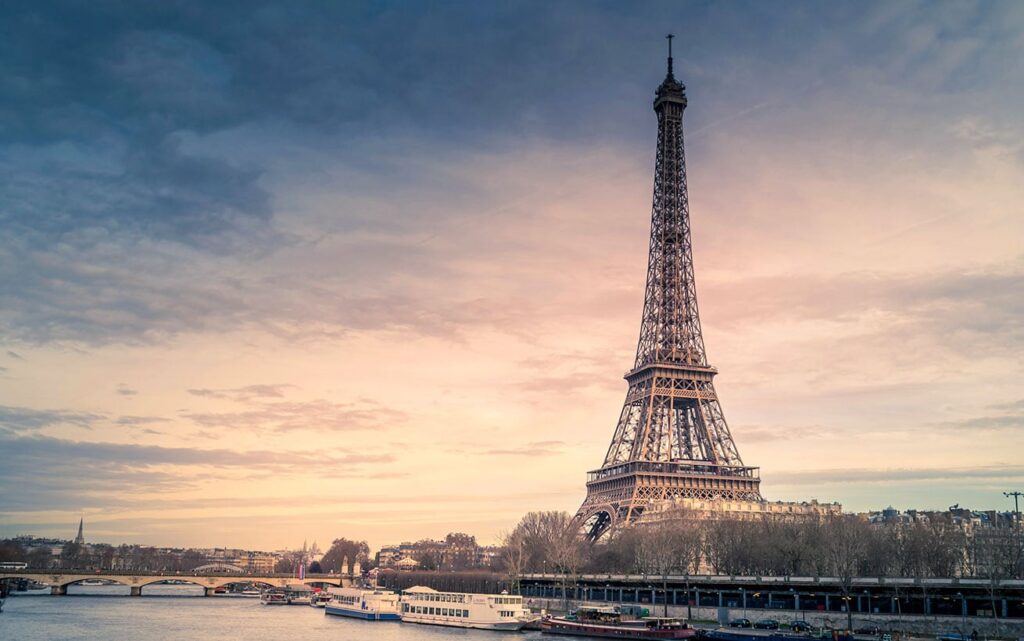 A picturesque image of the Eiffel Tower in Paris at sunset.