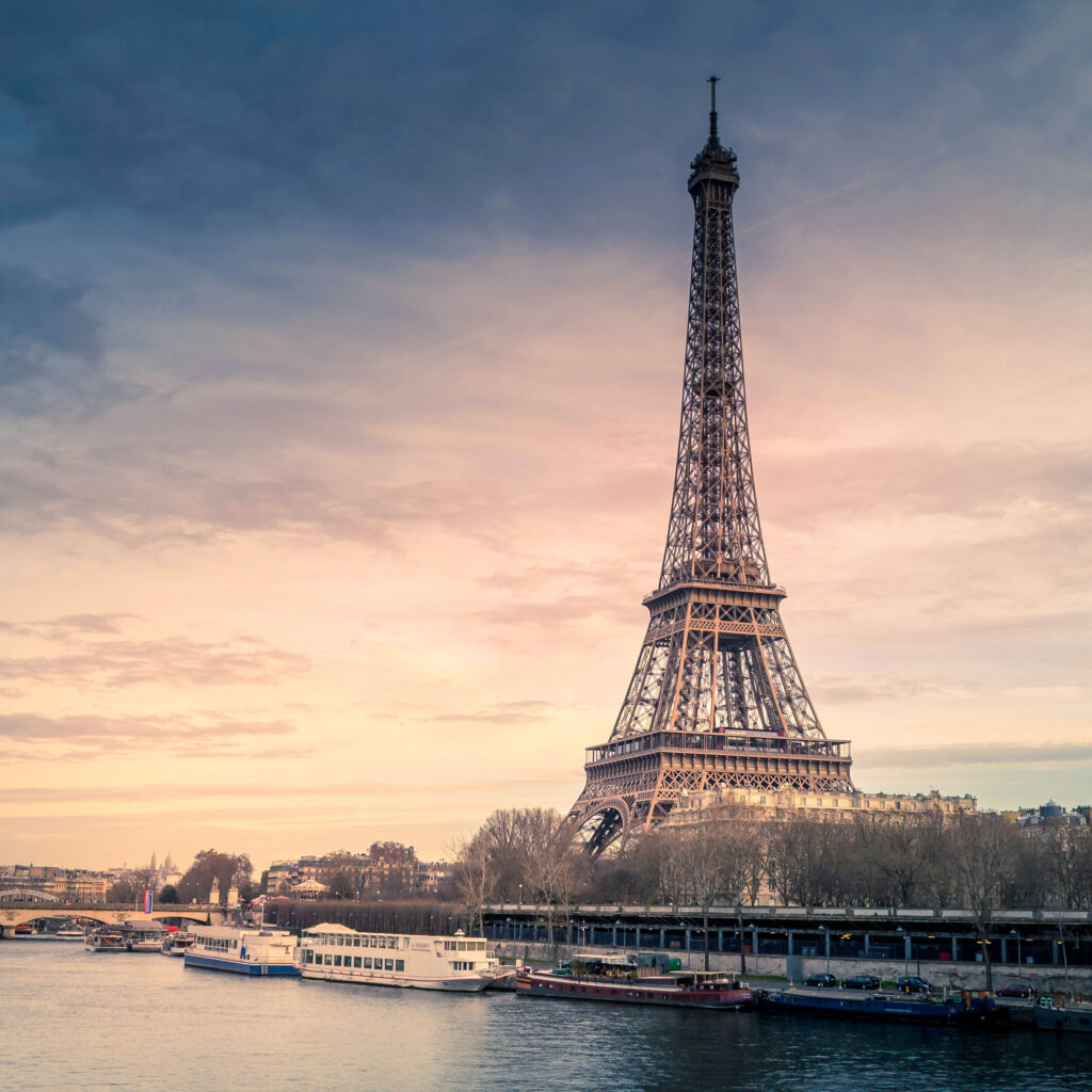 A picturesque image of the Eiffel Tower in Paris at sunset.