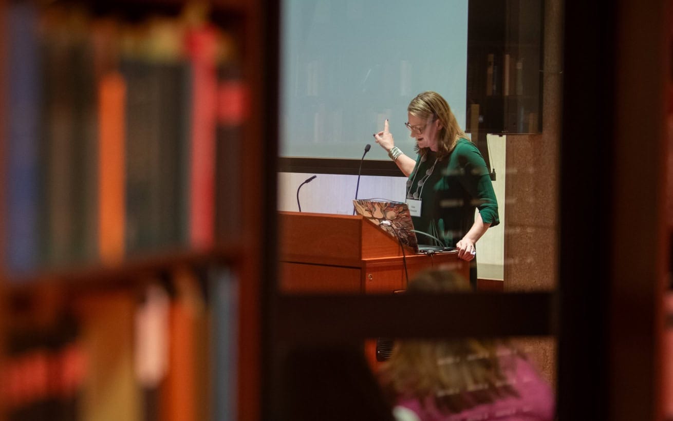 A lady delivering a lecture in a library