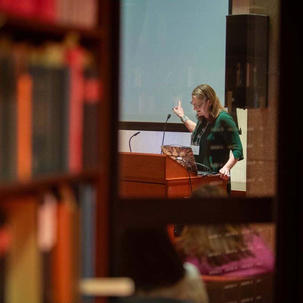 A lady delivering a lecture in a library