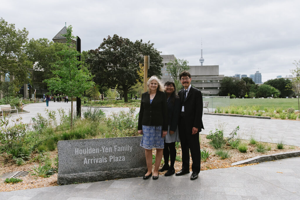 Photo of the Houlden-Yen family in front of the Houlden-Yen Family Arrivals plaza sign.