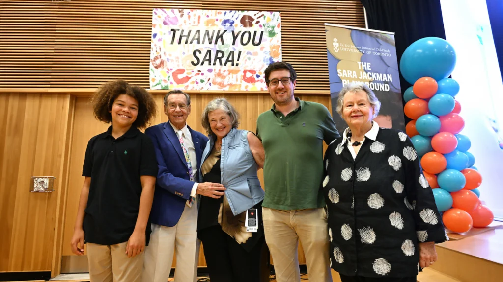 Five people posing in front of a sign that reads, THANK YOU SARA!