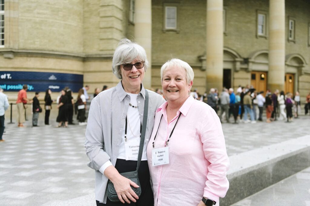 Photo of two attendees smiling together