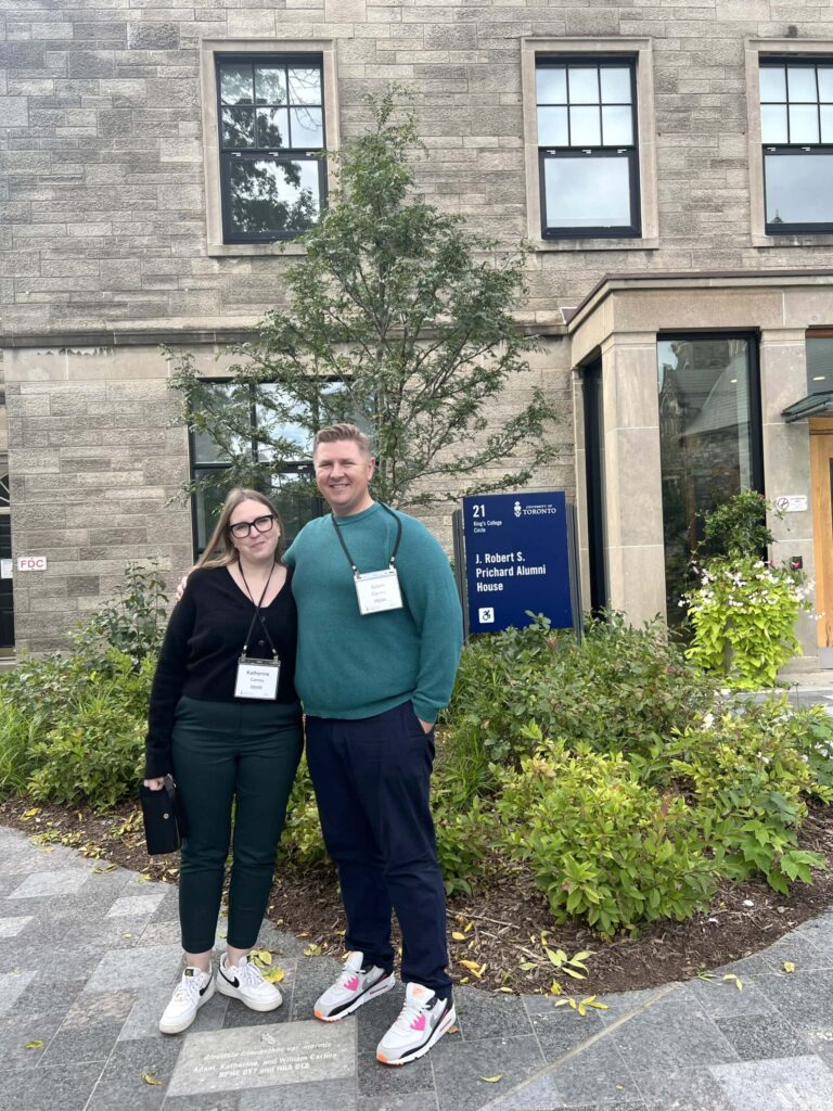 Photo of two attendees smiling together