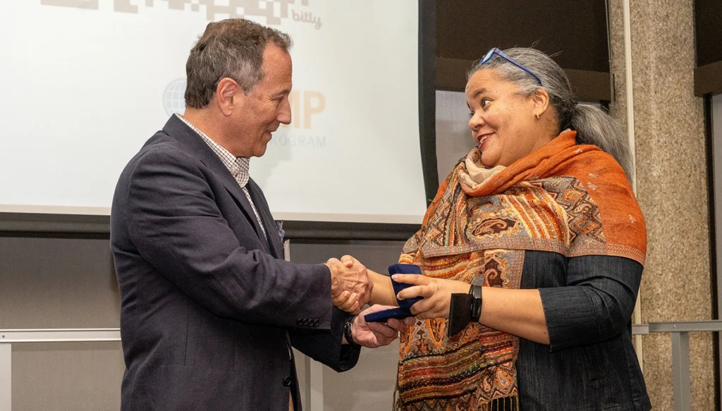 Two people shaking hands on a stage