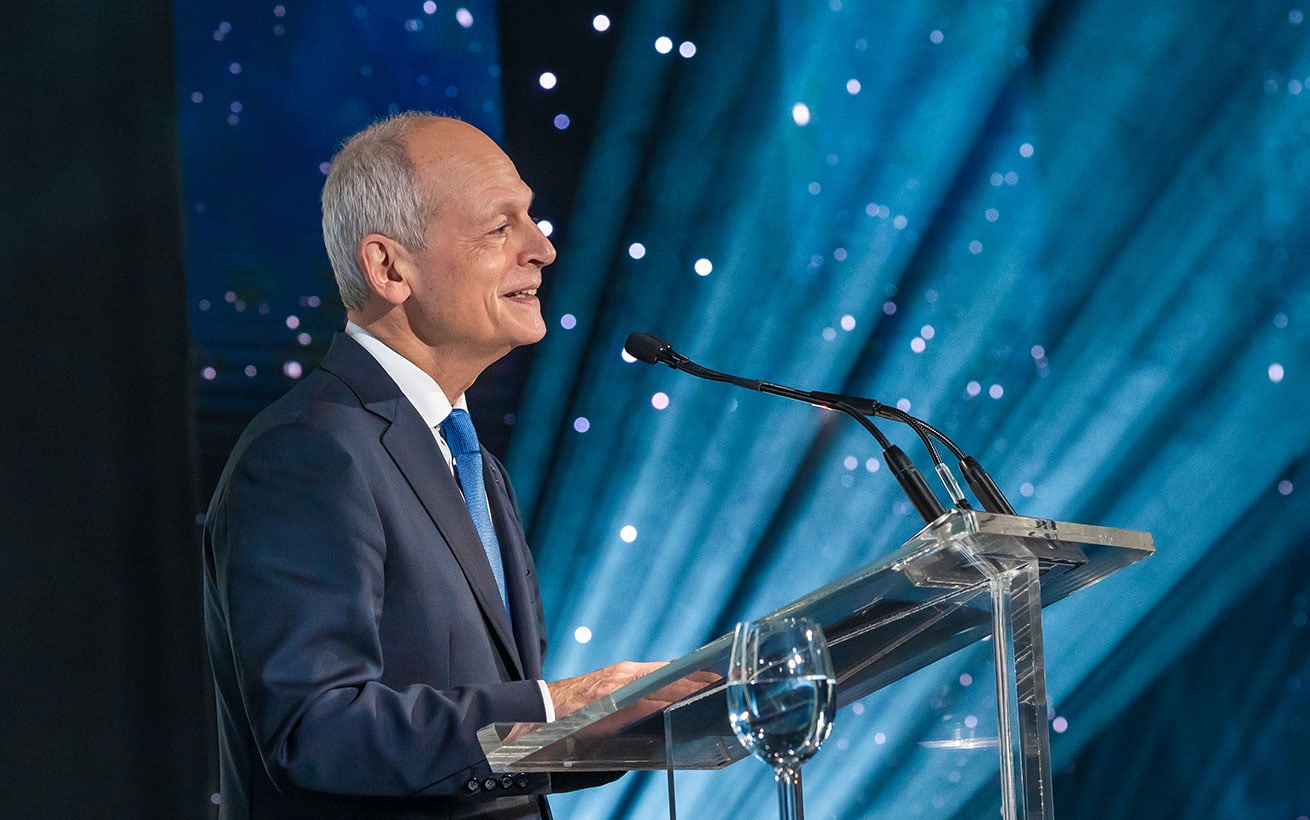 President Meric Gertler stands at a podium giving a speech