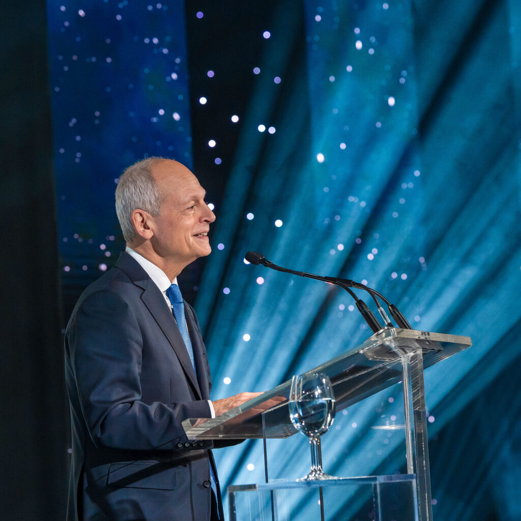 President Meric Gertler stands at a podium giving a speech