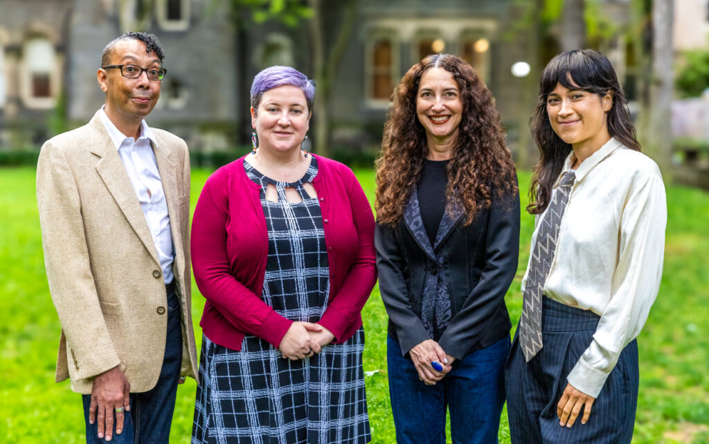 A group of four people posing for a photo