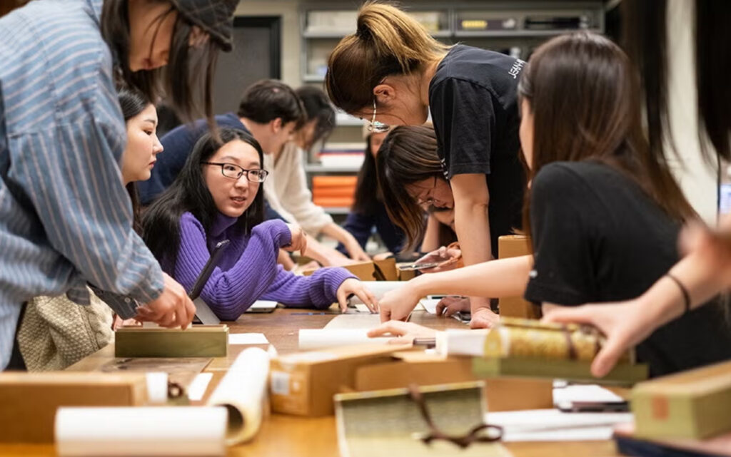 A group of students at a large table working together