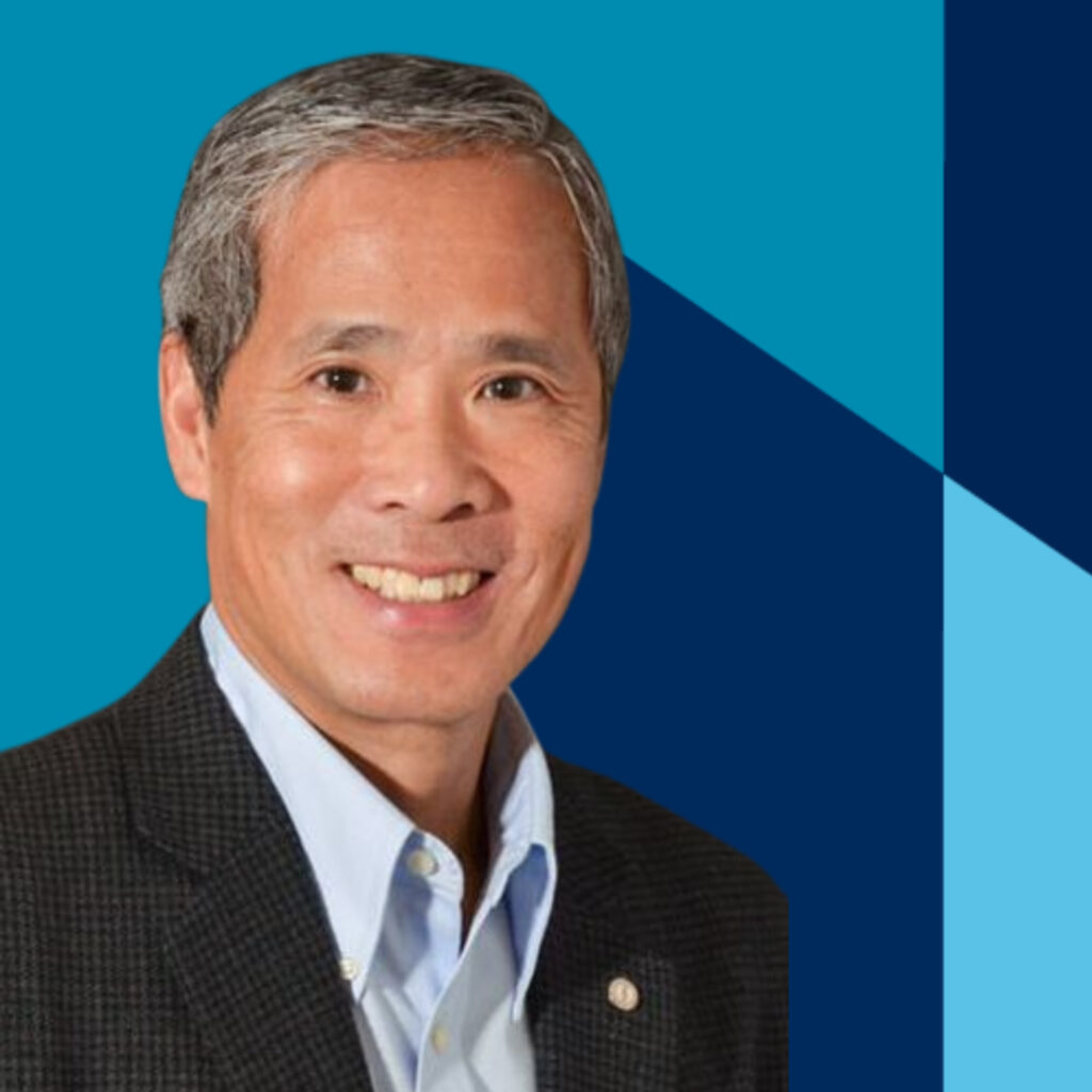 A portrait of a man in front of a graphic blue backdrop