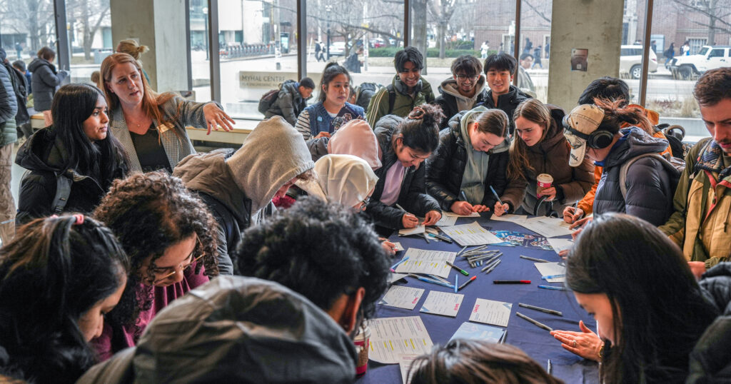 Engineering students gather around the 'Thank You Lab,' a pop-up booth inviting them to write messages of appreciation to donors