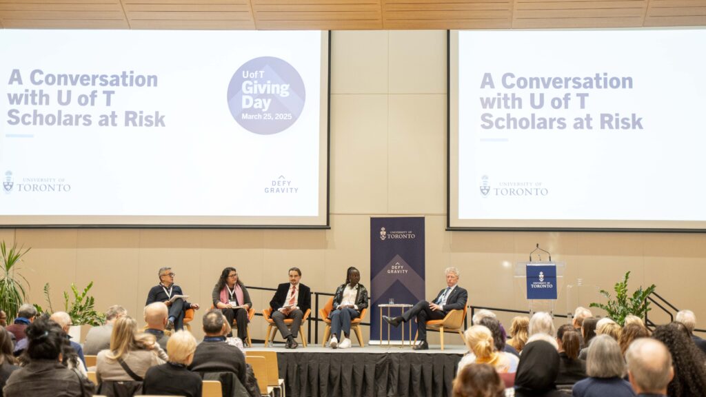 A panel discussion on a stage.
