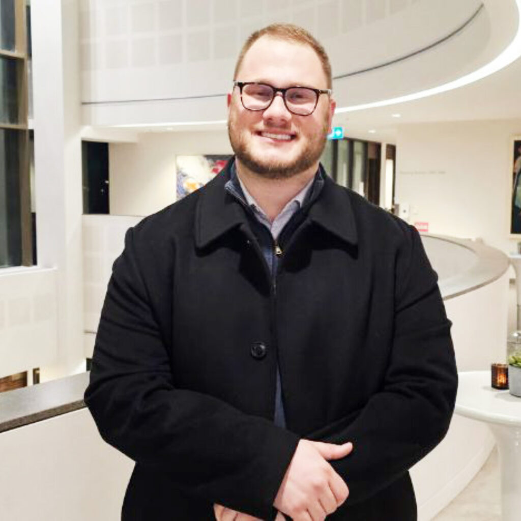 A person standing in a white building. 