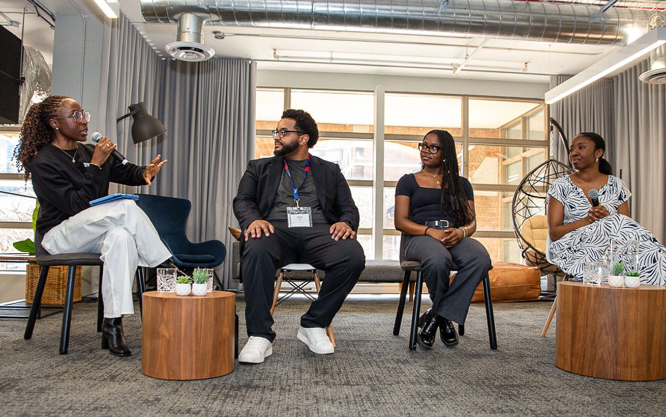 four people seated on stage at the Black Founders Network event